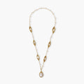 14K gold plated necklace with organic leaf motifs and freshwater pearls arranged in an elegant chain design on neutral background.