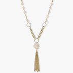 Long gold-plated necklace with freshwater pearls, chunky chain links, and flowing tassel pendant