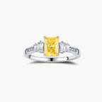 Yellow moissanite jewelry set with emerald-cut stones in sterling silver halo settings on white background.