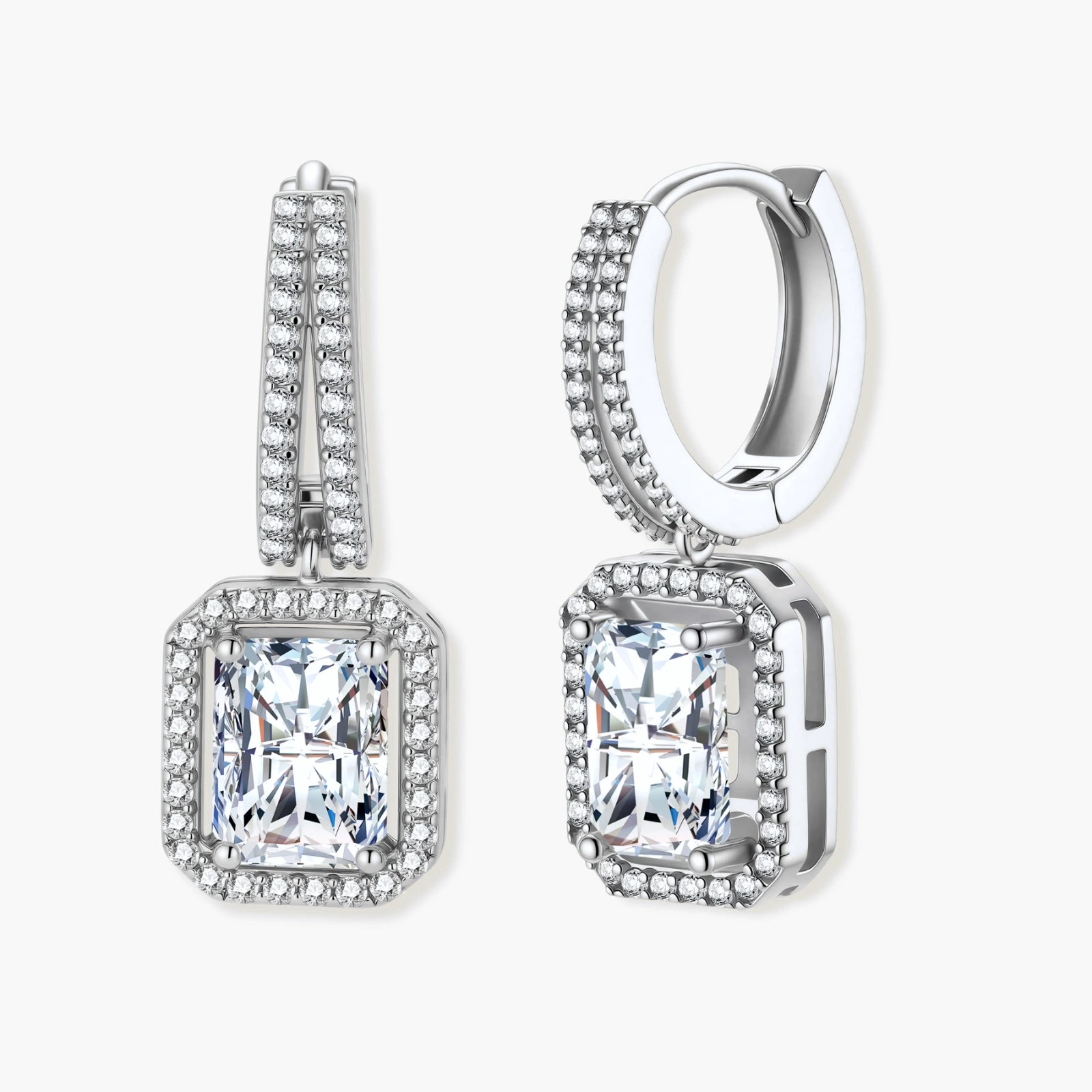 Sterling silver huggie hoops with emerald-cut moissanite drops featuring pavé-set crystals on white background.