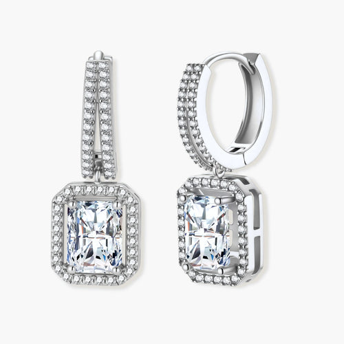 Sterling silver huggie hoops with emerald-cut moissanite drops featuring pavé-set crystals on white background.