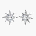 Sterling silver star-shaped stud earrings with brilliant moissanite center stones and pavé details on neutral background.