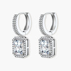 Sterling silver huggie hoops with emerald-cut moissanite drops featuring pavé-set crystals on white background.