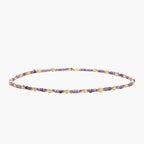 Delicate 18K gold vermeil necklace with alternating lavender zirconia beads and white freshwater pearls on cream background