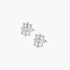 Ornate sterling silver stud earrings with mandala-inspired filigree pattern and four freshwater pearls on beige background