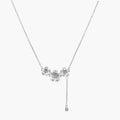 White gold plated Y-shaped necklace with three dimensional flower charms and adjustable drop pendant