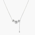 White gold plated Y-shaped necklace with three dimensional flower charms and adjustable drop pendant