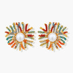Vibrant starburst stud earrings with multicolor enamel rays and white pearl centers on gold-plated setting