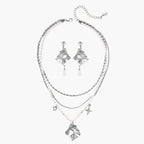 Ornate silver-toned masquerade mask jewelry set featuring rhinestone details and pearl drop earrings on white background.