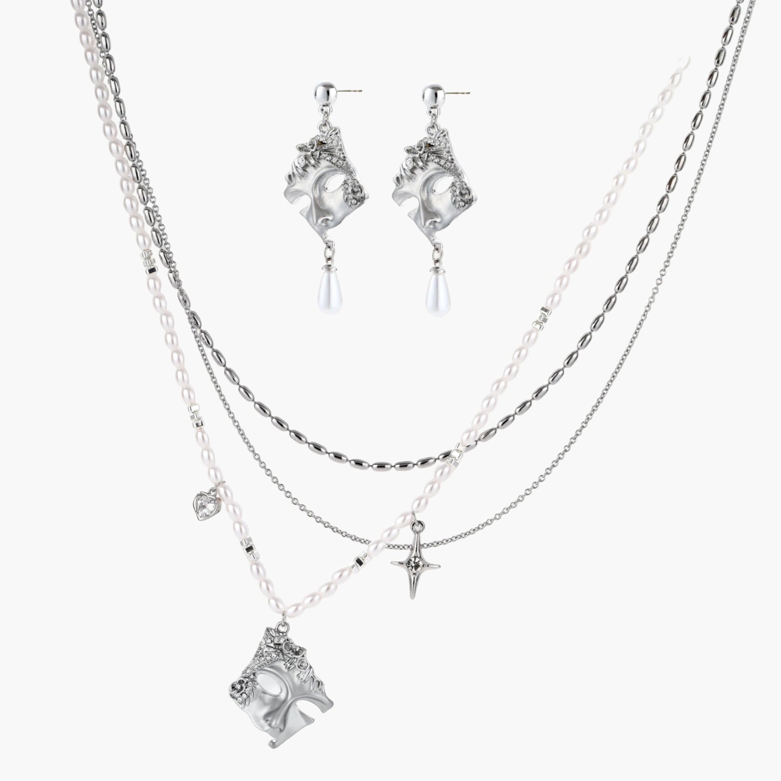 Ornate silver-toned masquerade mask jewelry set featuring rhinestone details and pearl drop earrings on white background.