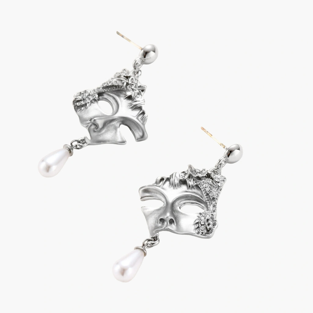Ornate silver-toned masquerade mask jewelry set featuring rhinestone details and pearl drop earrings on white background.