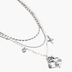 Ornate silver-toned masquerade mask jewelry set featuring rhinestone details and pearl drop earrings on white background.