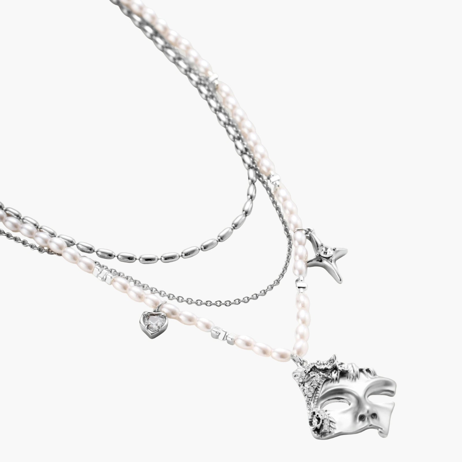 Ornate silver-toned masquerade mask jewelry set featuring rhinestone details and pearl drop earrings on white background.