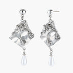 Ornate silver-toned masquerade mask jewelry set featuring rhinestone details and pearl drop earrings on white background.