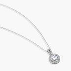 Platinum-plated sterling silver necklace with round halo pendant featuring central crystal surrounded by smaller stones