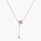 White gold plated jewelry set with pink cubic zirconia stones in geometric cross design, featuring Y-necklace and square stud earrings