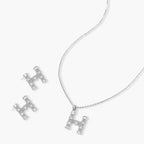 Letter H jewelry set featuring geometric crystal design in gold and white gold plated finish with adjustable chain necklace