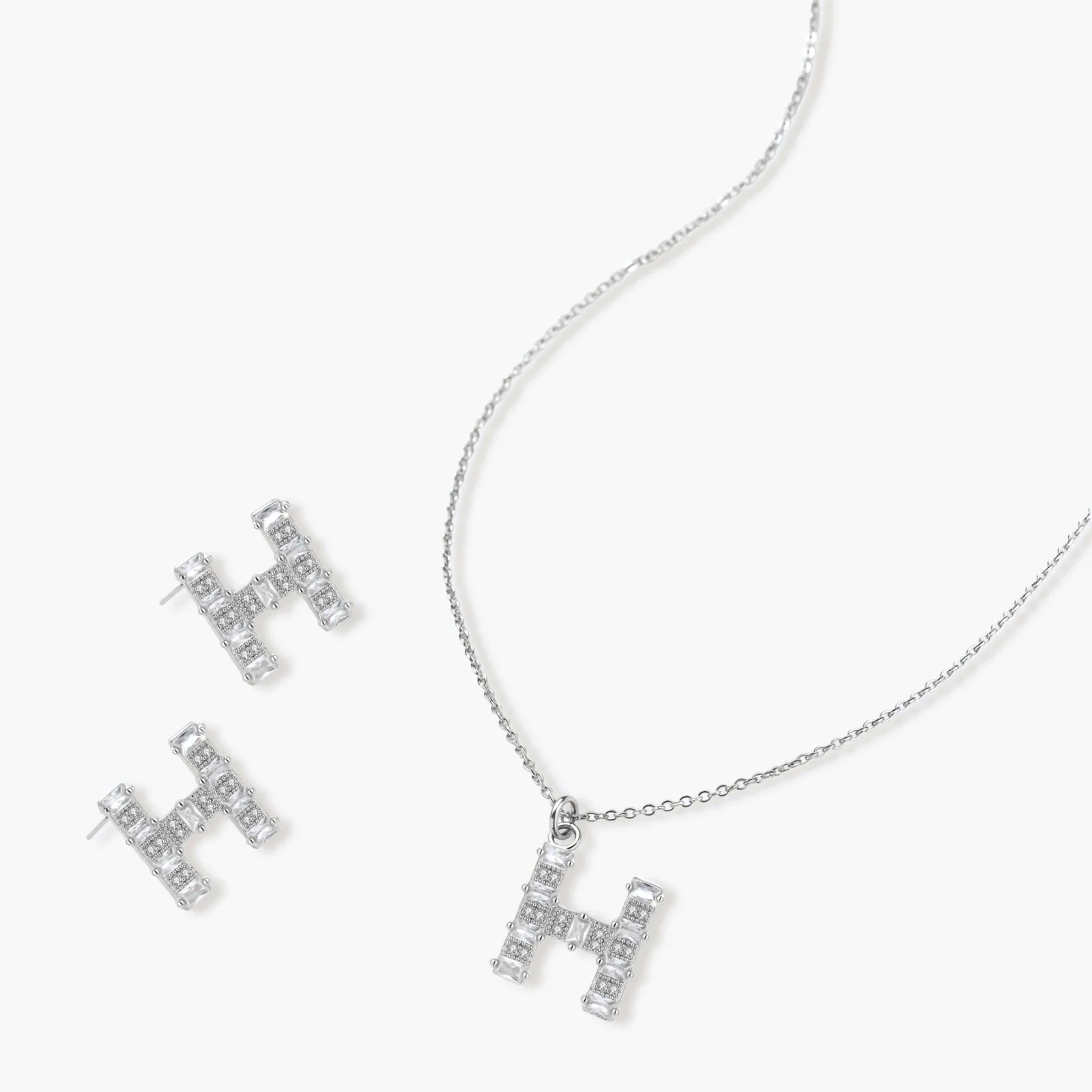 Letter H jewelry set featuring geometric crystal design in gold and white gold plated finish with adjustable chain necklace