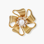 18K gold-plated bow brooch with dimensional ribbon design, pearl center, and sparkling zircon stones on white background.